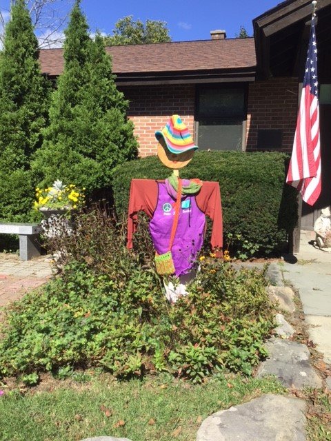 A scarecrow, put up by the Roscoe-Rockland Garden Club, oversees a sea of greenery.